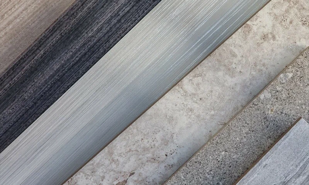 In this image, a person is seen installing floor tiles in a room. The tiles are laid out neatly on the floor, and the individual is working with a trowel to spread adhesive. The focus is on the installation process, which demonstrates the precision and attention to detail required for a successful tile laying project, ensuring an even and polished finish.