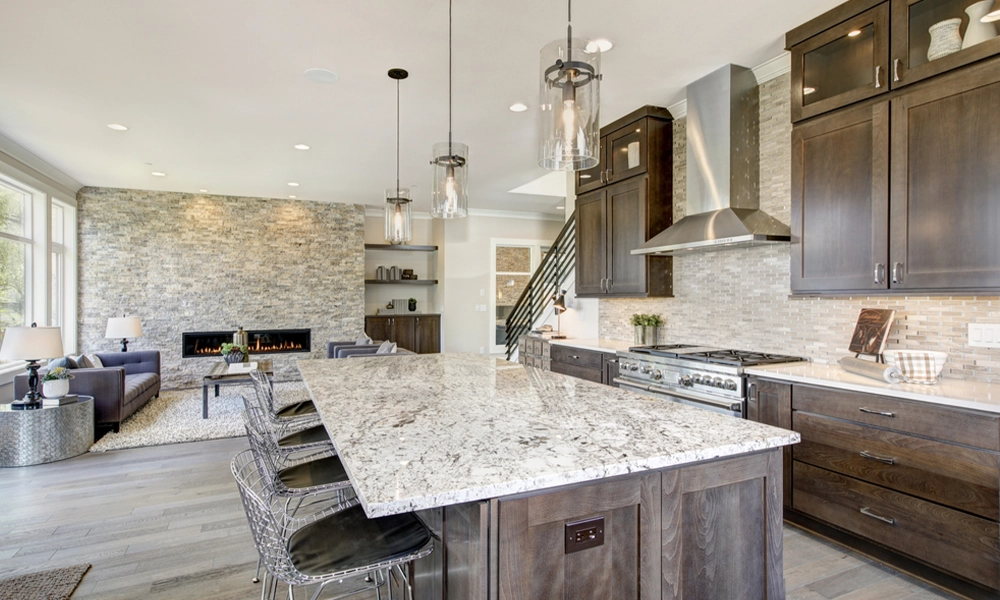 Luxury kitchen accented with large granite kitchen island, taupe tile backsplash