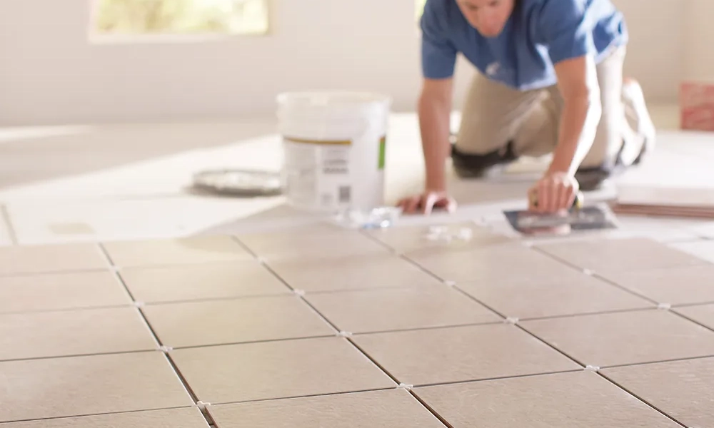 This image showcases a variety of ceramic floor tiles arranged in a line. The tiles feature a range of neutral tones such as gray, beige, and light brown, with some having a more textured or smooth finish. These tiles are ideal for modern interior spaces, providing a clean, sophisticated, and timeless aesthetic for flooring.